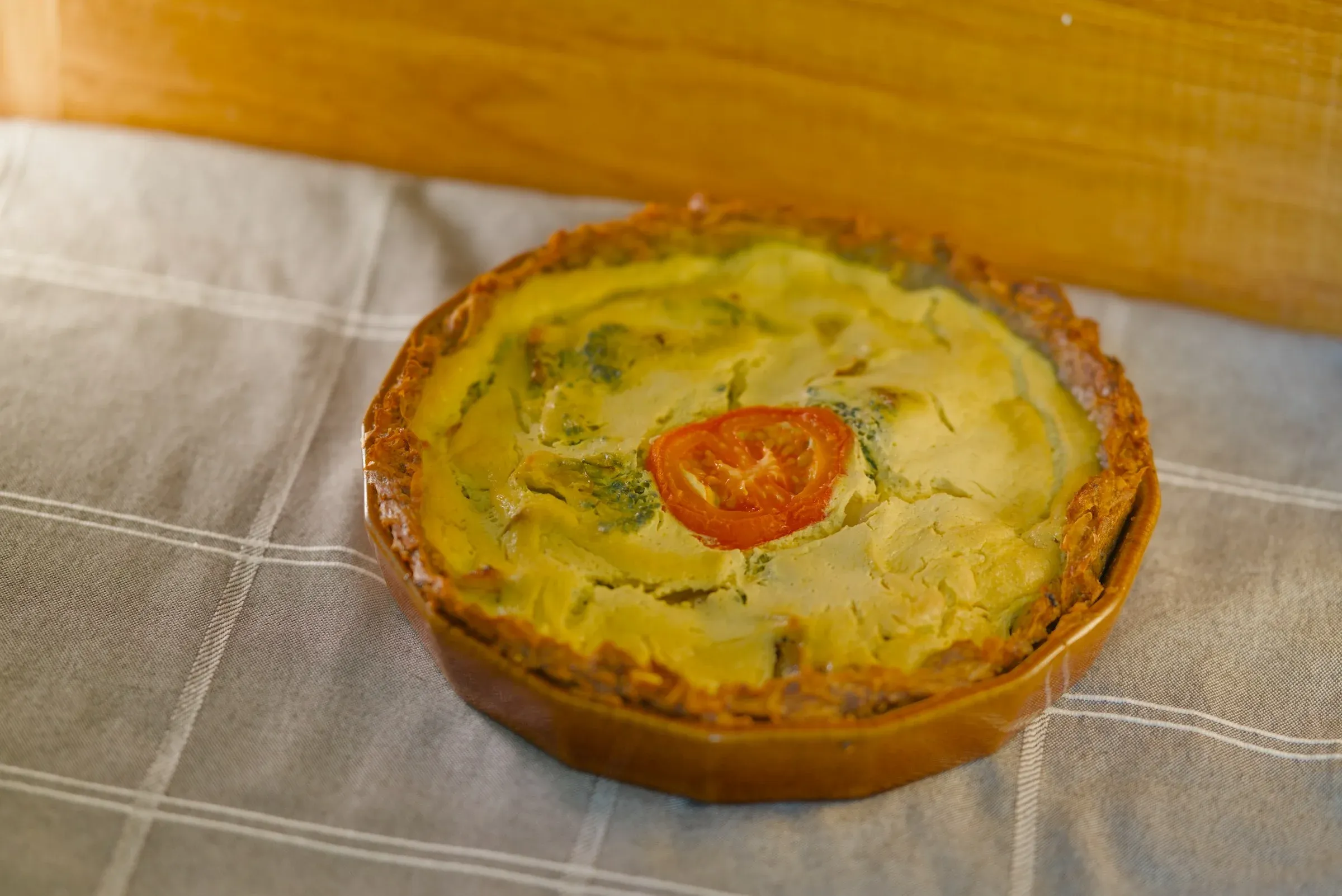 Slices of broccoli quiche arranged on a serving board.