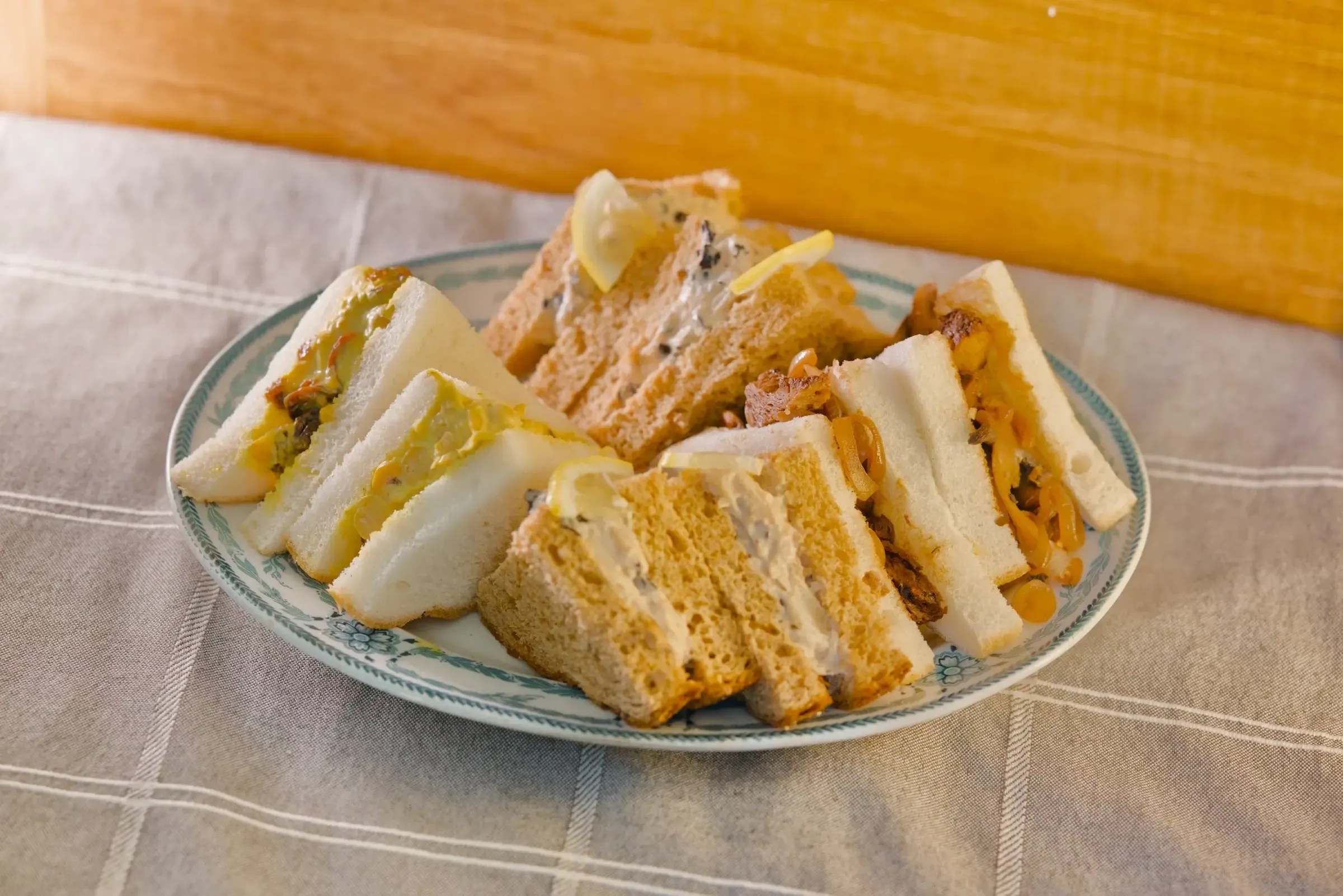 Coronation chickpea sandwiches arranged for a cold buffet.