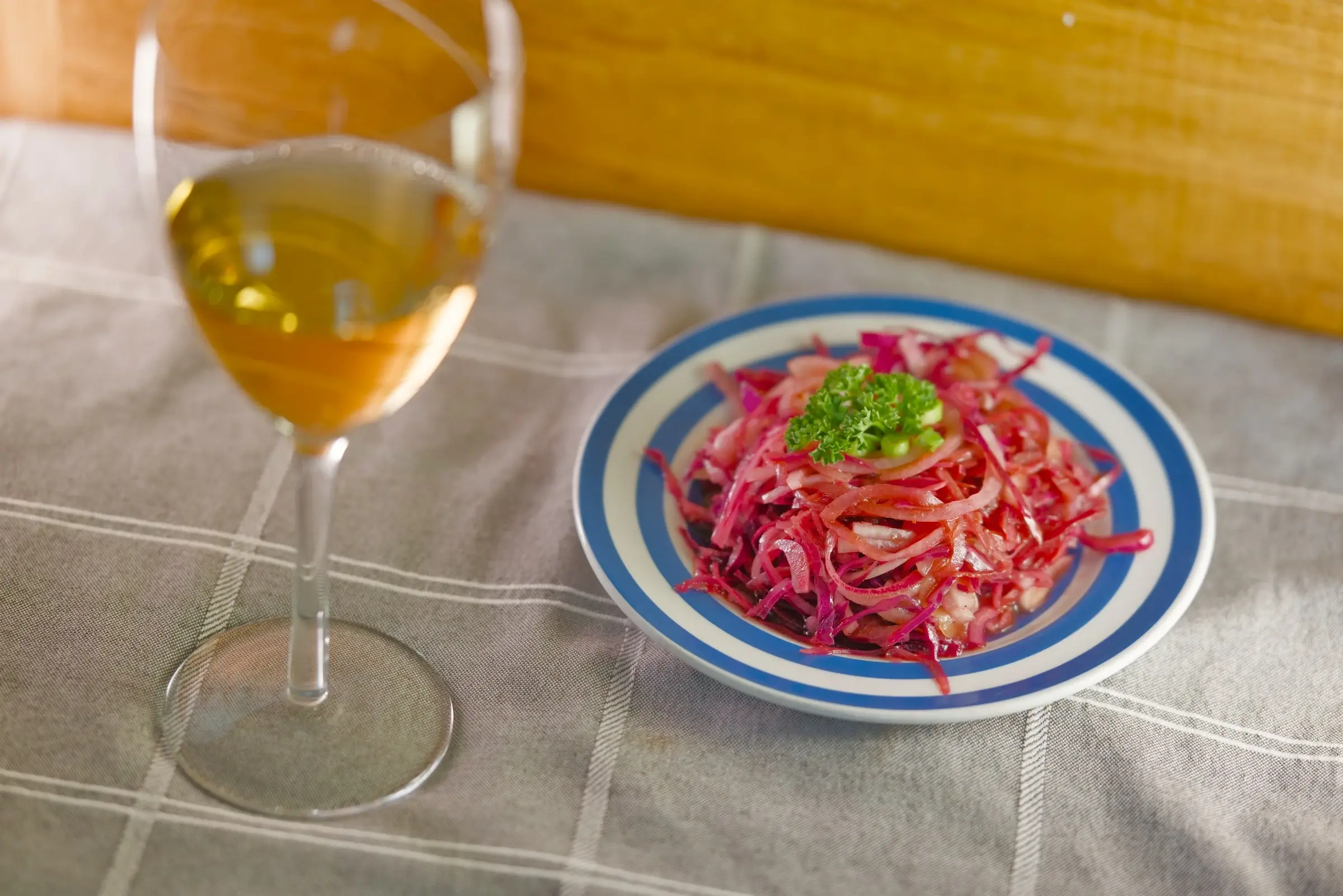 Red cabbage and onion slaw in a serving dish.
