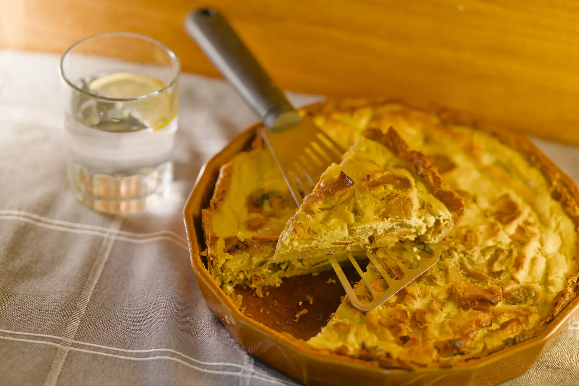 Vegan bacon and mushroom quiche cut into slices.