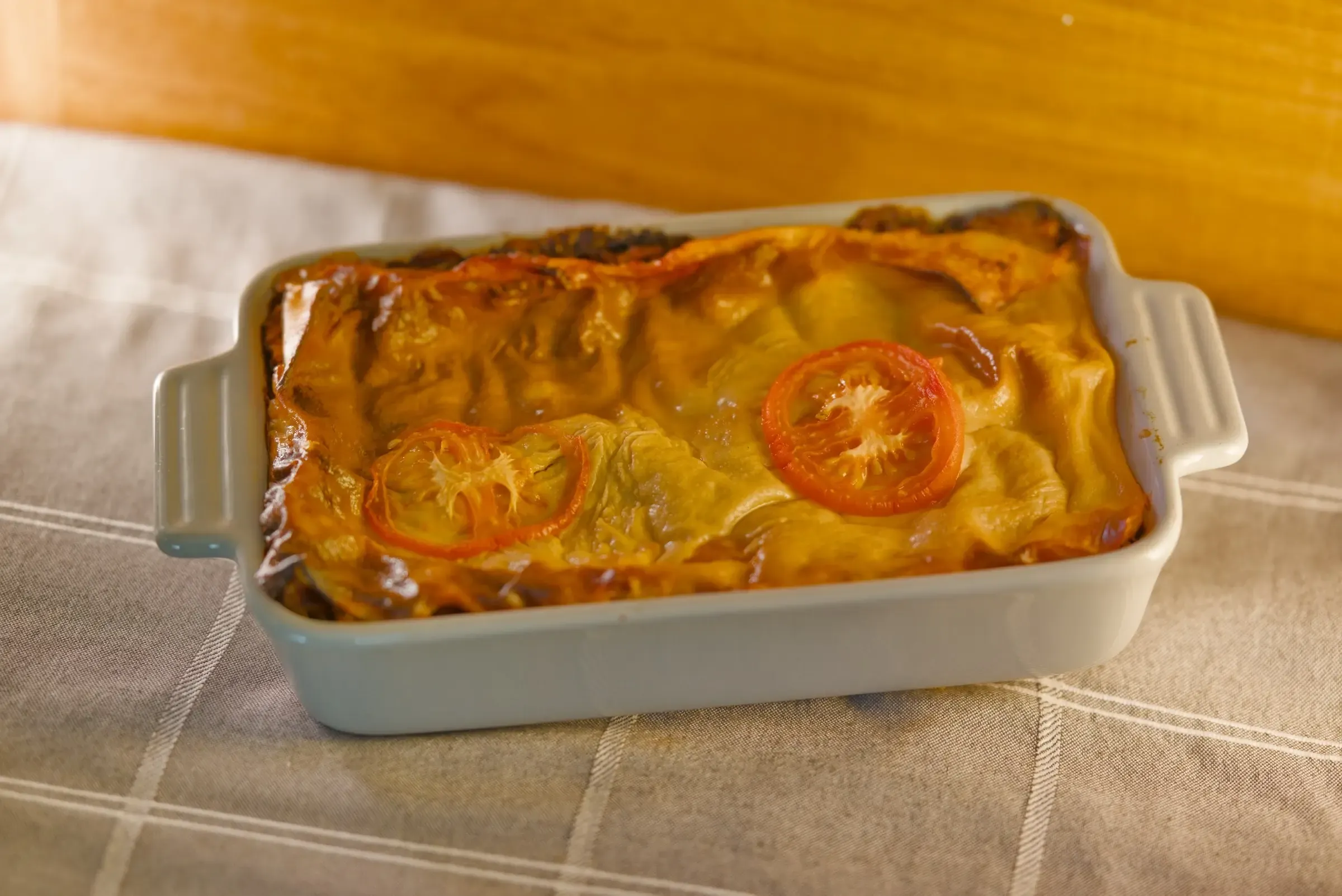 Plant-based lasagne showing pasta and filling layers.